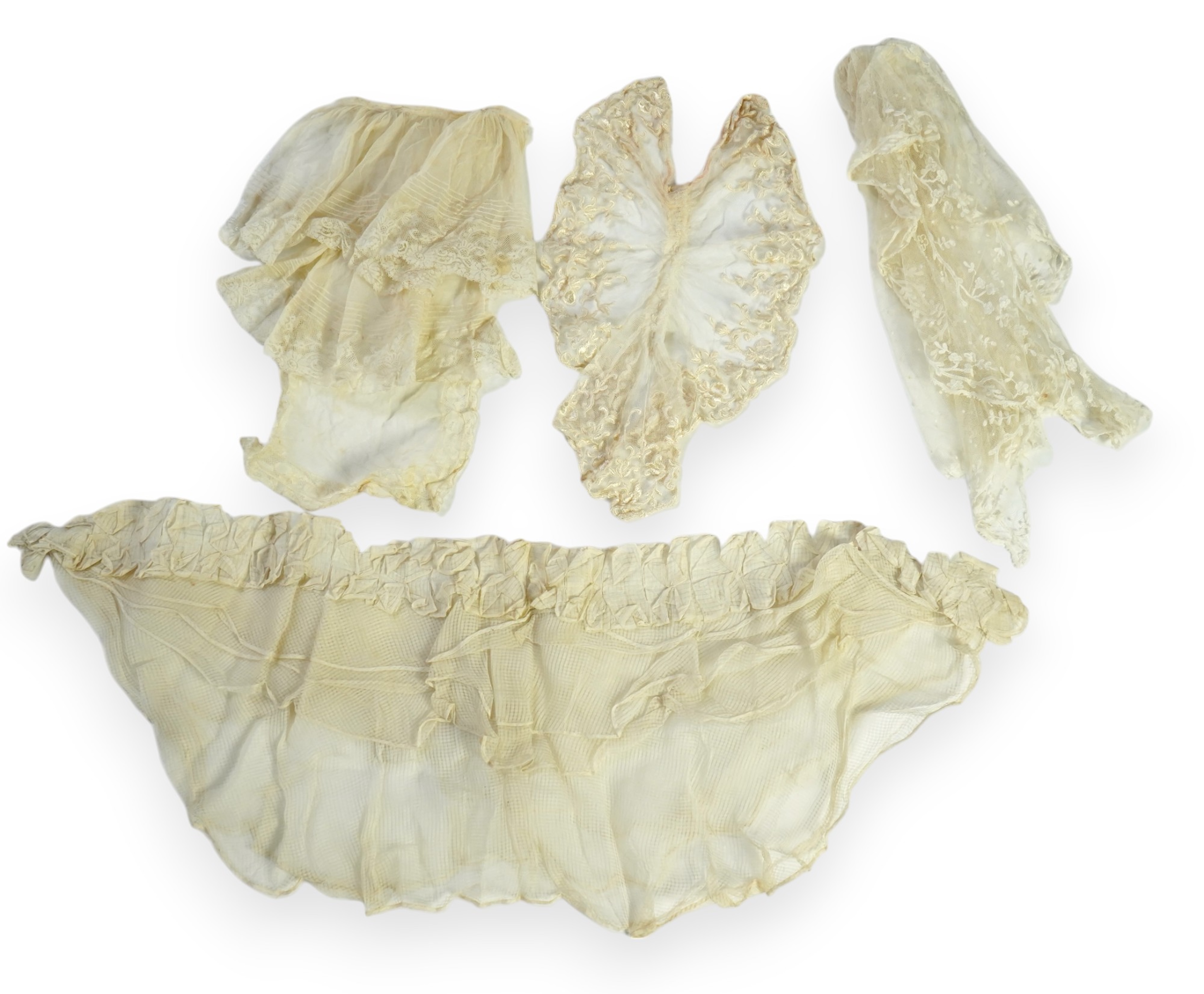 A suitcase containing a cream silk lace skirt to a dress, an Edwardian silk petticoat and various collars, possibly for theatrical use, silk petticoat 96 cm long. Condition - fair